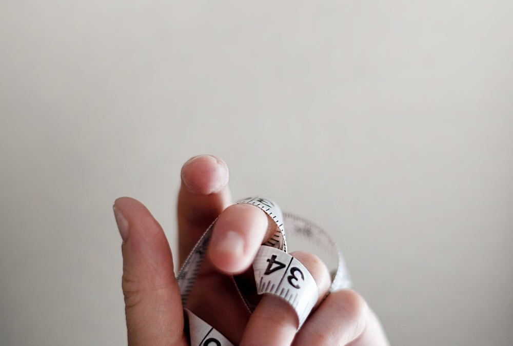 A measuring tape wrapped around a hand