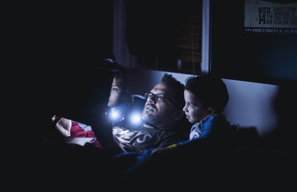 A dad and kids in bed